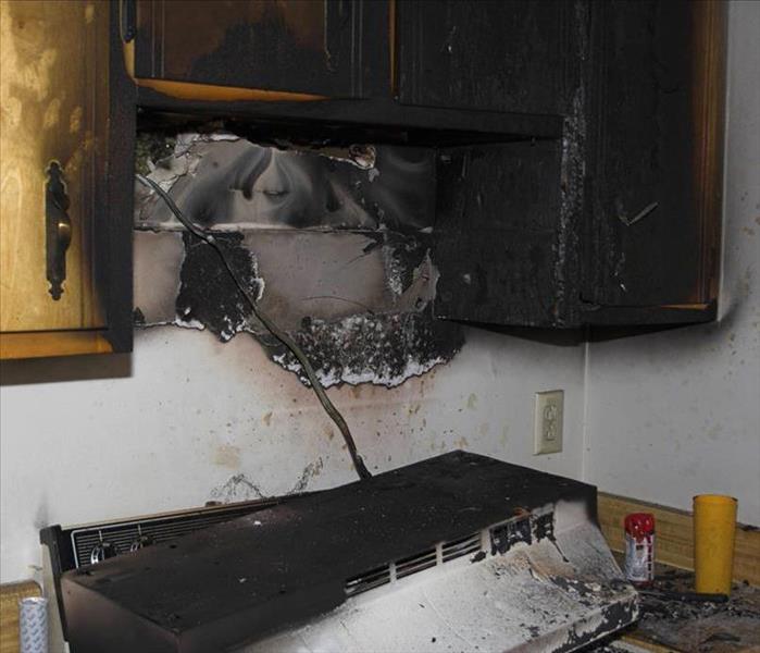 Kitcken fire hood over oven fell and cabinets chard from flames.